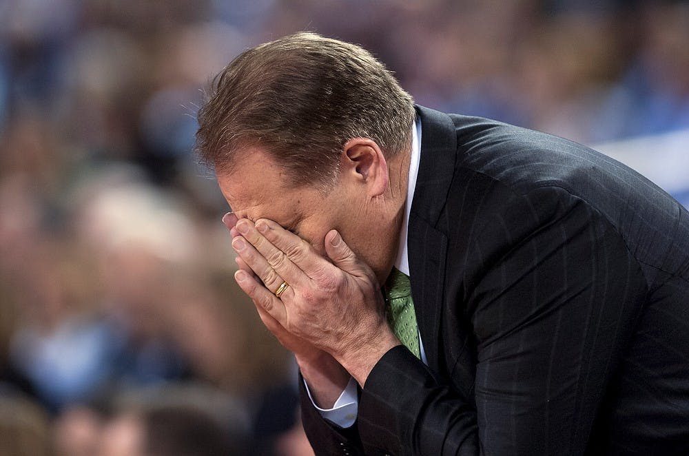 <p>Head coach Tom Izzo buries his face in his hands after the final buzzer April 4, 2015, during the semi-final game of the NCAA Tournament in the Final Four round at Lucas Oil Stadium in Indianapolis, Indiana. The Spartans were defeated by the Blue Devils, 81-61. Erin Hampton/The State News</p>
