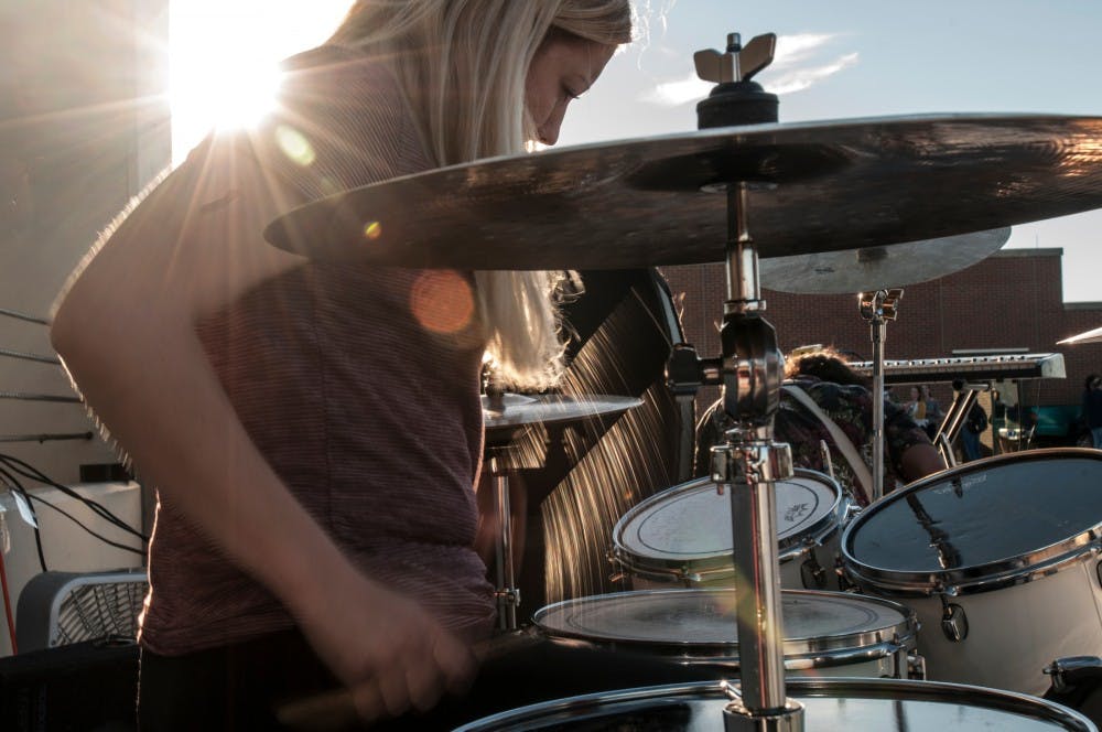 Drummer Gin Everett of the band "Marvels" performs during a concert Sept. 12, 2016 on top of the Communications arts & sciences parking ramp at 211 N. Harrison Road. The band played a free, hour-long concert for students. 