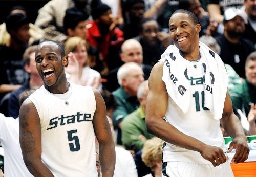 MSU senior guard Travis Walton and freshman forward Delvon Roe celebrate teammate, junior forward Jon Crandell’s first points of the game. The Spartans finished the night with a 75-47 victory over the Hoosiers, on February 7, 2009, at Breslin Center.