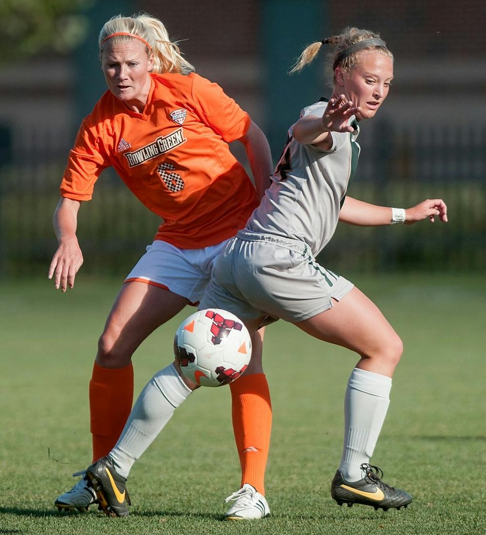 	<p>Bowling Green midfielder/forward Kaitlyn Tobin fights for control of the ball against freshman forward Erica Goodenough during the game on Sept. 13, 2013 at DeMartin Stadium at Old College Field. The Spartans defeated the Falcons, 3-1. Georgina De Moya/The State News</p>