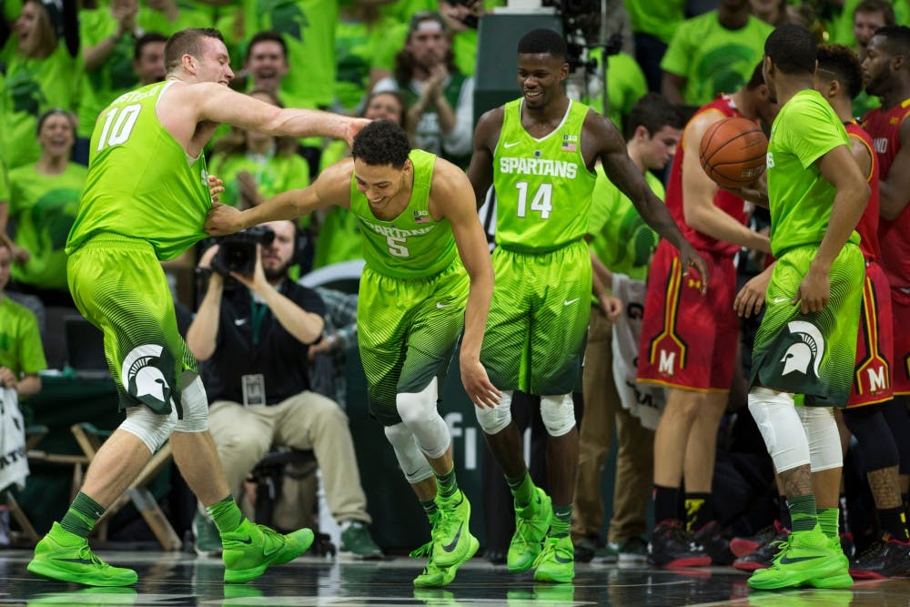 From left to right, senior forward Matt Costello, senior guard Bryn Forbes, and junior guard Eron Harris celebrate after scoring during the  game against Maryland on Jan. 23, 2016 at Breslin Center. The Spartans defeated the Terrapins, 74-65.