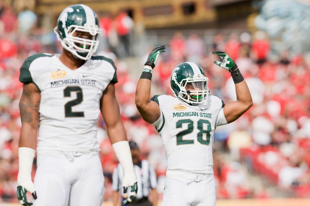 From left, sophomore defensive tackle William Gholston and sophomore linebacker Denicos Allen try to fire the crowd up. The Michigan State Spartans defeated the Georgia Bulldogs in triple overtime, 33-30, Monday afternoon at the Outback Bowl hosted in Raymond James Stadium at Tampa, Fla. Justin Wan/The State News