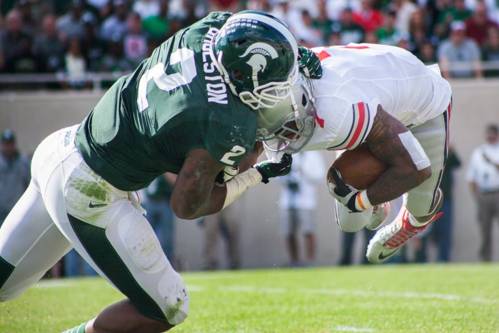 	<p>Junior defensive end William Gholston tackles Ohio State running back Jordan Hall during a game on Saturday, Sept. 29, 2012 at Spartan Stadium.  The Spartans trailed behind the Buckeyes at halftime and eventually lost the game 17-16. Julia Nagy/The State News</p>