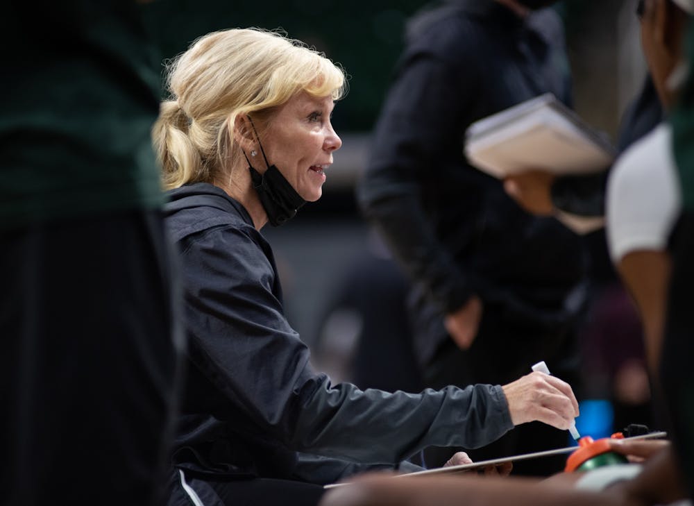 <p>Head coach Suzy Merchant sits with the team leading into the fourth quarter of their match against the Nebraska Cornhuskers at the Breslin on Thursday, Dec. 30, 2021. </p>