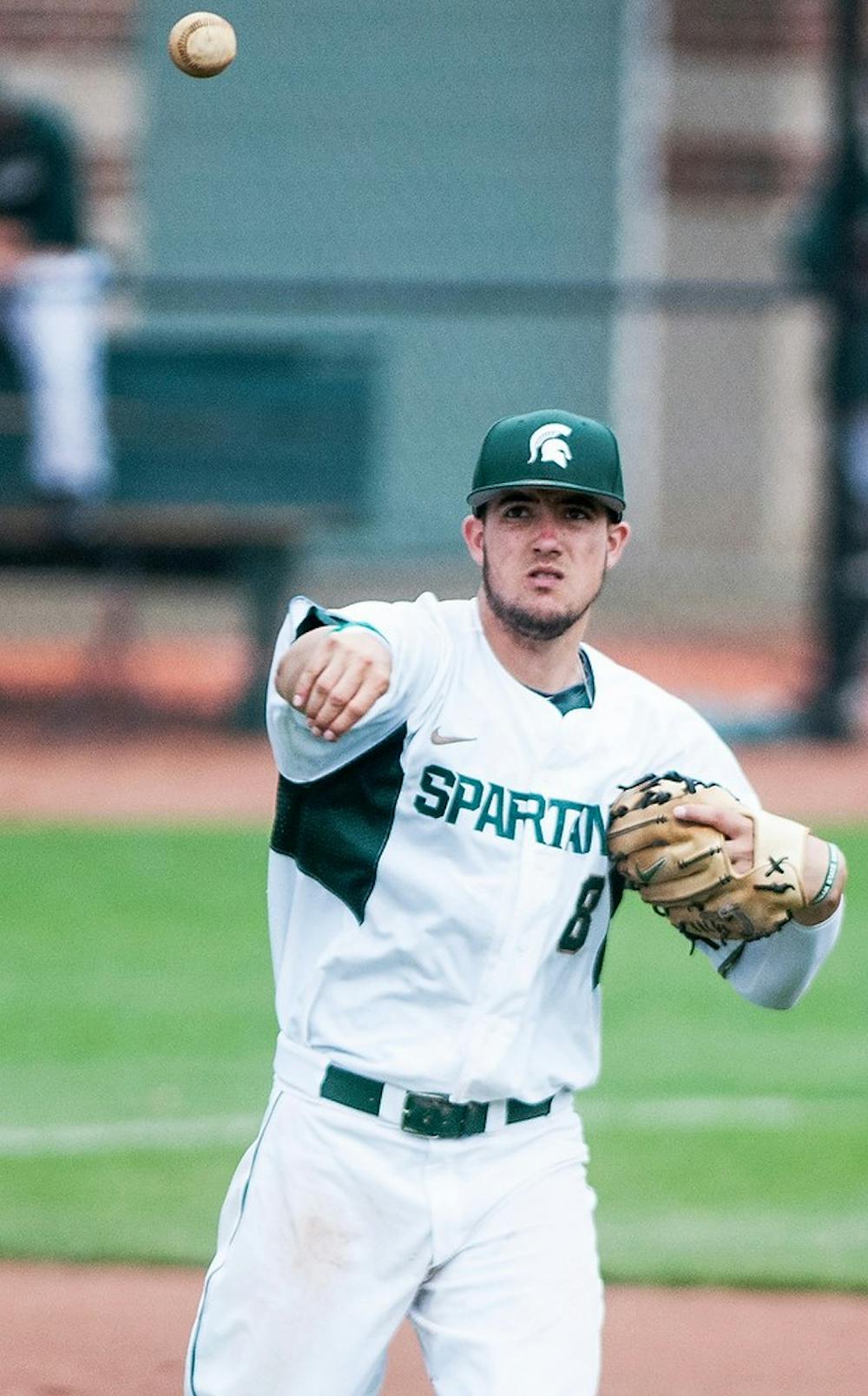 <p>Sophomore third baseman Justin Hovis makes a throw during the game against Nebraska on May 12, 2014, at McLane Baseball Stadium at Old College Field. The game was called due to lightning in the bottom of the eighth, and the Cornhuskers defeated the Spartans, 4-1. Corey Damocles/The State News</p>