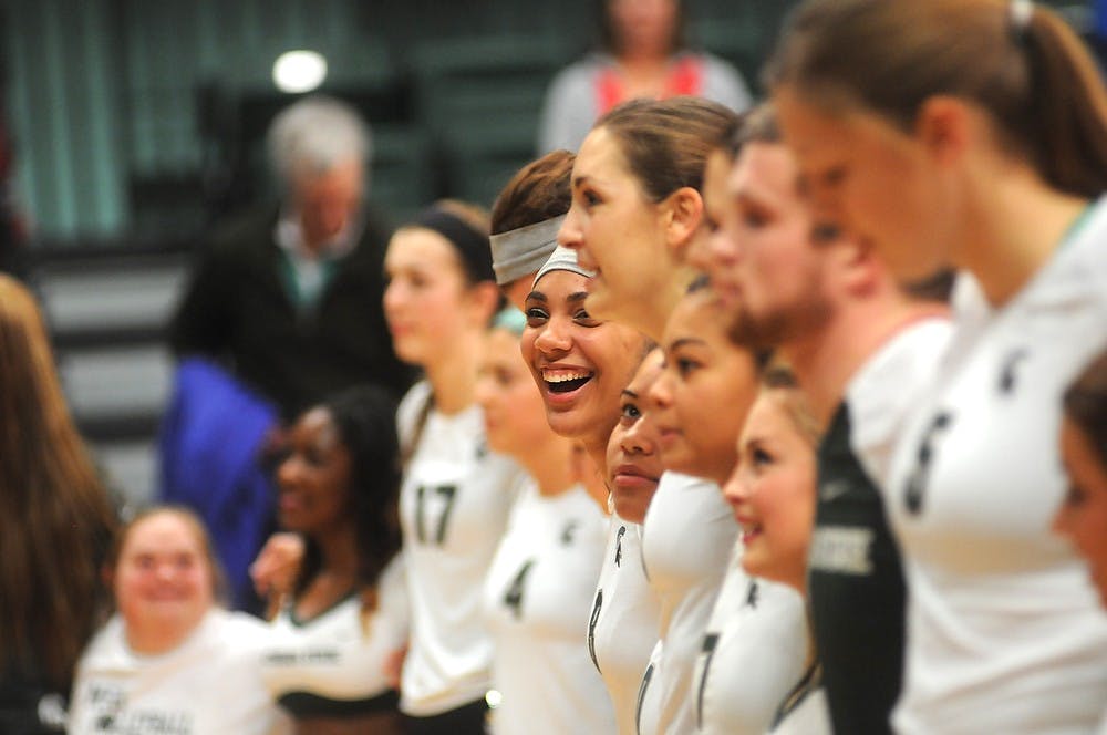 <p>The team lines up with the cheerleaders and other fans Nov. 22, 2014 after their victory against Rutgers at Jenison Field House. The Spartans defeated the Scarlet Knights, 3-0. Dylan Vowell/The State News</p>