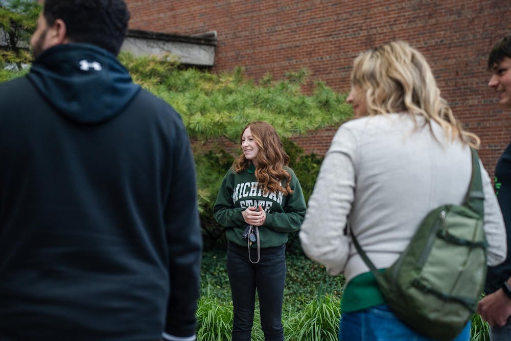 <p>MSU junior and student tour guide Jenna Jacobs tours a group around campus on April 29, 2023.</p>