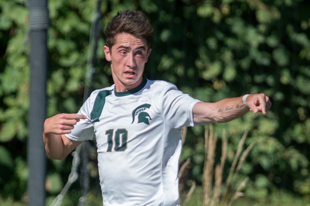	<p>Sophomore midfielder Jay Chapman points to his team after scoring a goal during the game against Northern Illinois on Sept. 28, 2013, at DeMartin Stadium at Old College Field. The Spartans defeated the Huskies, 2-0. Julia Nagy/The State News</p>
