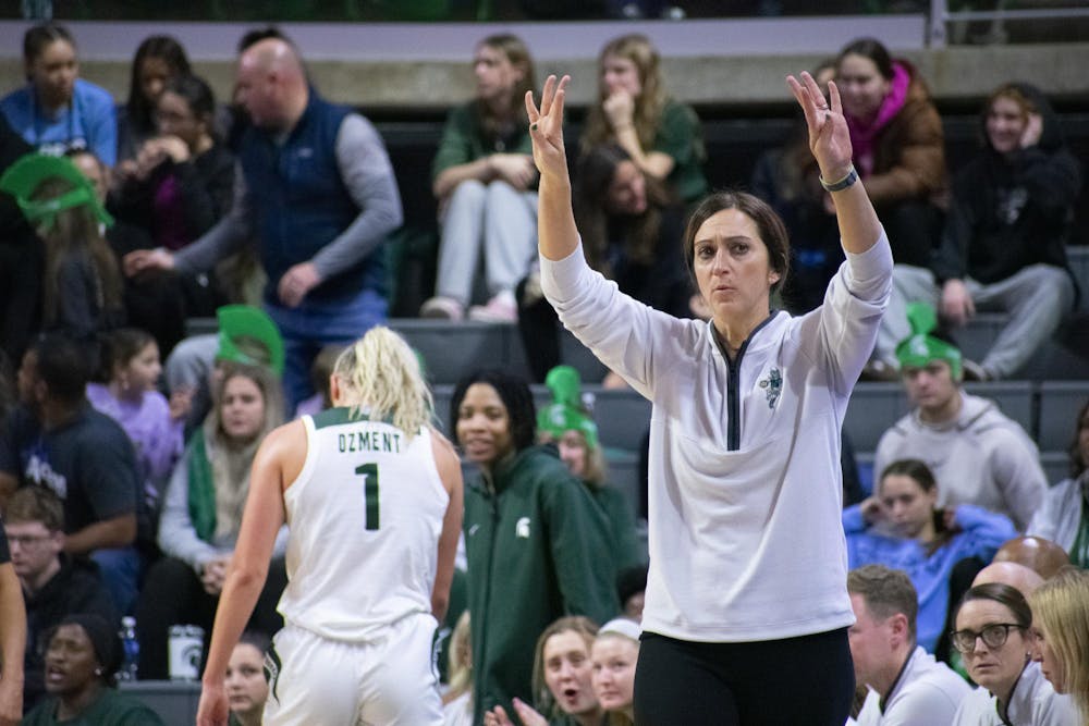 Michigan State University women’s basketball head coach Robyn Fralick signals the players on the court while graduate guard Tory Ozment (1) returns to the bench during a game against Nebraska at the Breslin Center on Dec. 9, 2023. The Spartans lost to the Cornhuskers 74-80. 
