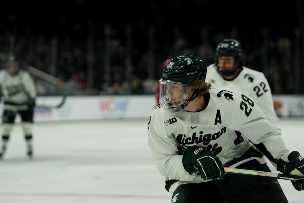 <p>Michigan State's Karsen Dorwart (28) chases the play against Wisconsin at Munn Ice Arena on Nov. 17, 2023,.</p>
