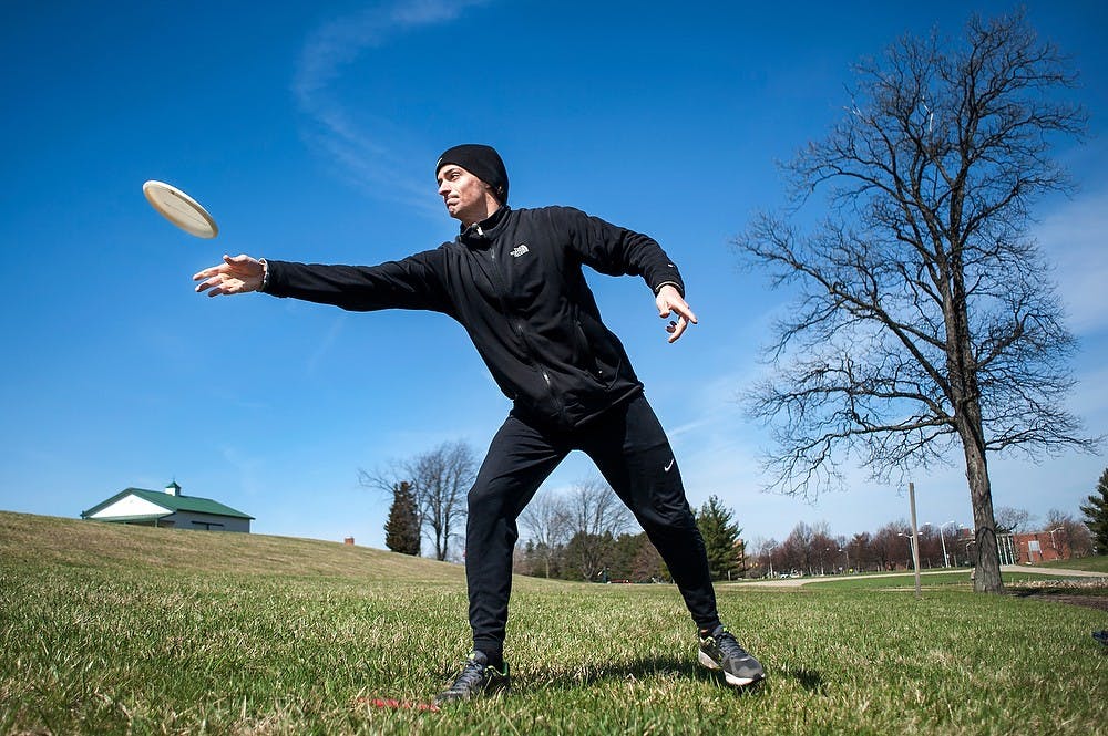 	<p>Civil engineering junior Drake Veitenheimer attempts to get the frisbee into a hole Saturday at the Agricultural Exposition site off East Crescent Road during a fundraiser for the <span class="caps">MSU</span> Disc Golf Club. Justin Wan/The State News</p>