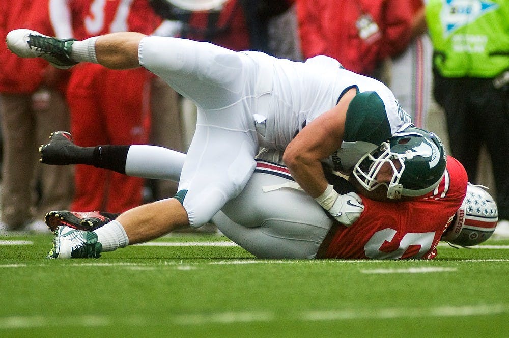 	<p>Sophomore linebacker Max Bullough sacks Ohio State quarterback Braxton Miller during the first half of Saturday&#8217;s game at Ohio Stadium in Columbus, Ohio. Bullough had one sack for seven yards during the game. Lauren Wood/The State News</p>