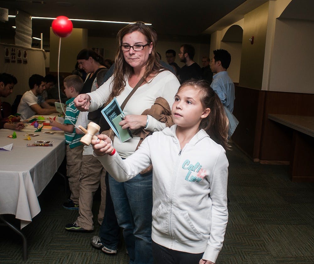 	<p>East Lansing resident Olivia Adlercrevtz plays the Japanese game of kendama at the Global Festival on Nov.11, 2012, at the Union.  Katie Stiefel/State News</p>