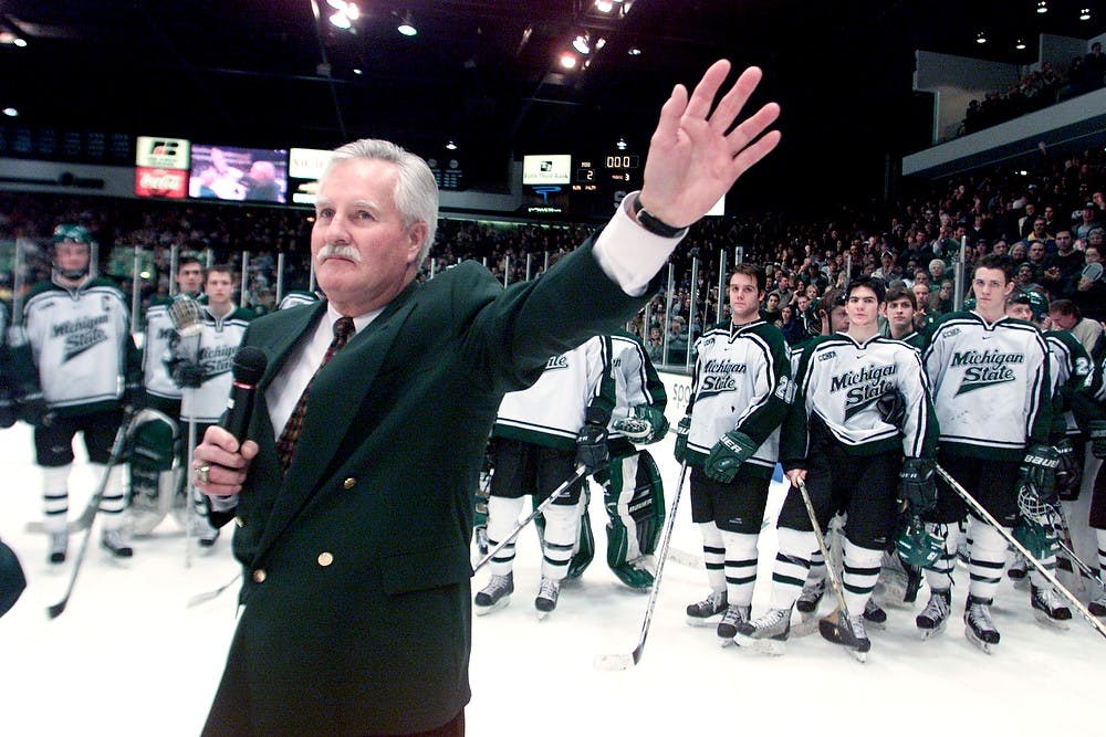 <p>Former hockey head coach Ron Mason waves to the fans at  Munn Ice Arena, March 2, 2002. State News File Photo</p>