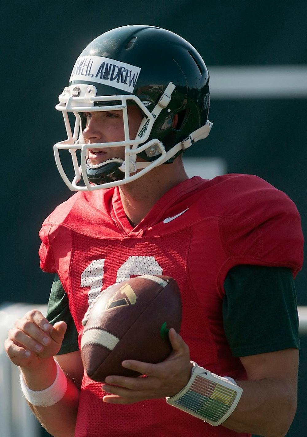 	<p>Senior quarterback Andrew Maxwell holds the ball during practice Aug. 19, 2013, at the practice field outside Duffy Daugherty Football Building. Julia Nagy/The State News</p>