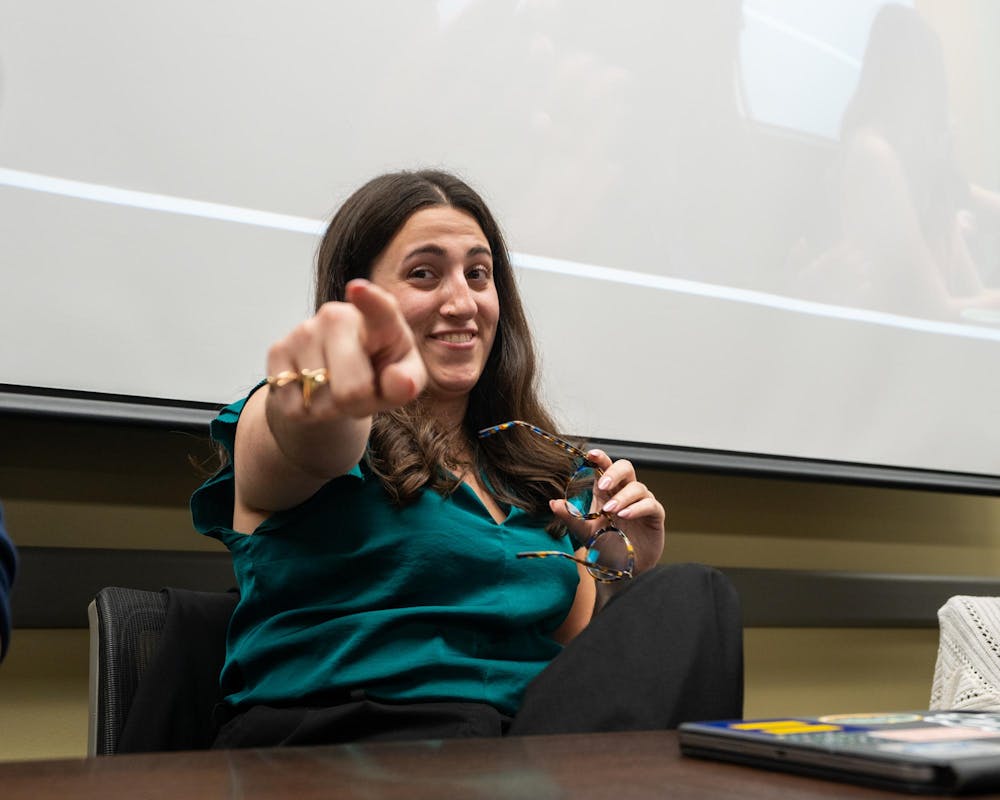 ASMSU future President, Maddie Hanes, points to the camera while holing back tears after winning her race for president in the Student Affairs & Services building in East Lansing, MI on April 14, 2026.