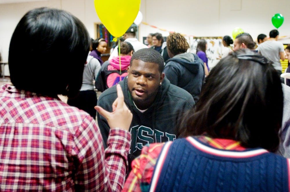 Chemistry freshman Peng Shuxia and general management freshman Dal Yuxias talk to kinesiology freshman Juwan Smith about the holidays associated with the Chinese culture. The Hubbard intercultural aids along with the Hubbard Hall student government hosted Cultural Check Point on Wednesday inside of Hubbard Hall. Anthony Thibodeau/The State News