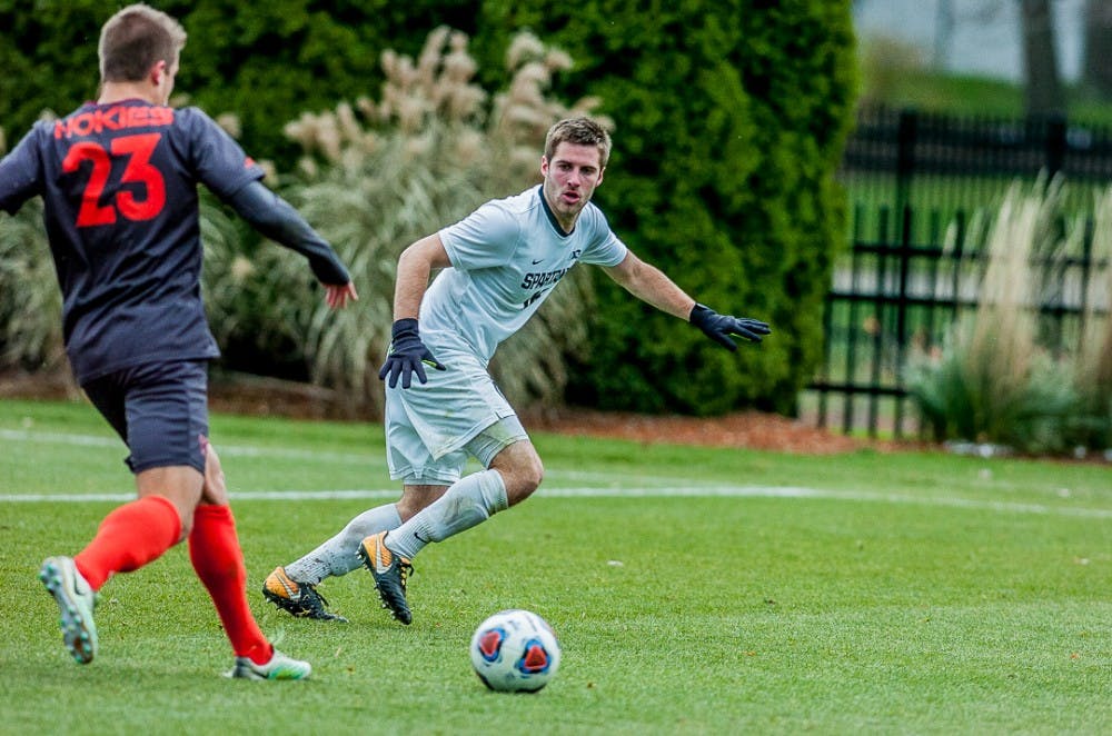 Junior defender Connor Corrigan (16) looks to steal the ball from senior midfielder Forrest White (23) during the game on Nov. 19, 2017 at DeMartin Stadium. The Spartans defeated the Hokies, 3-0, advancing them to the third round of the NCAA Soccer Tournament. 