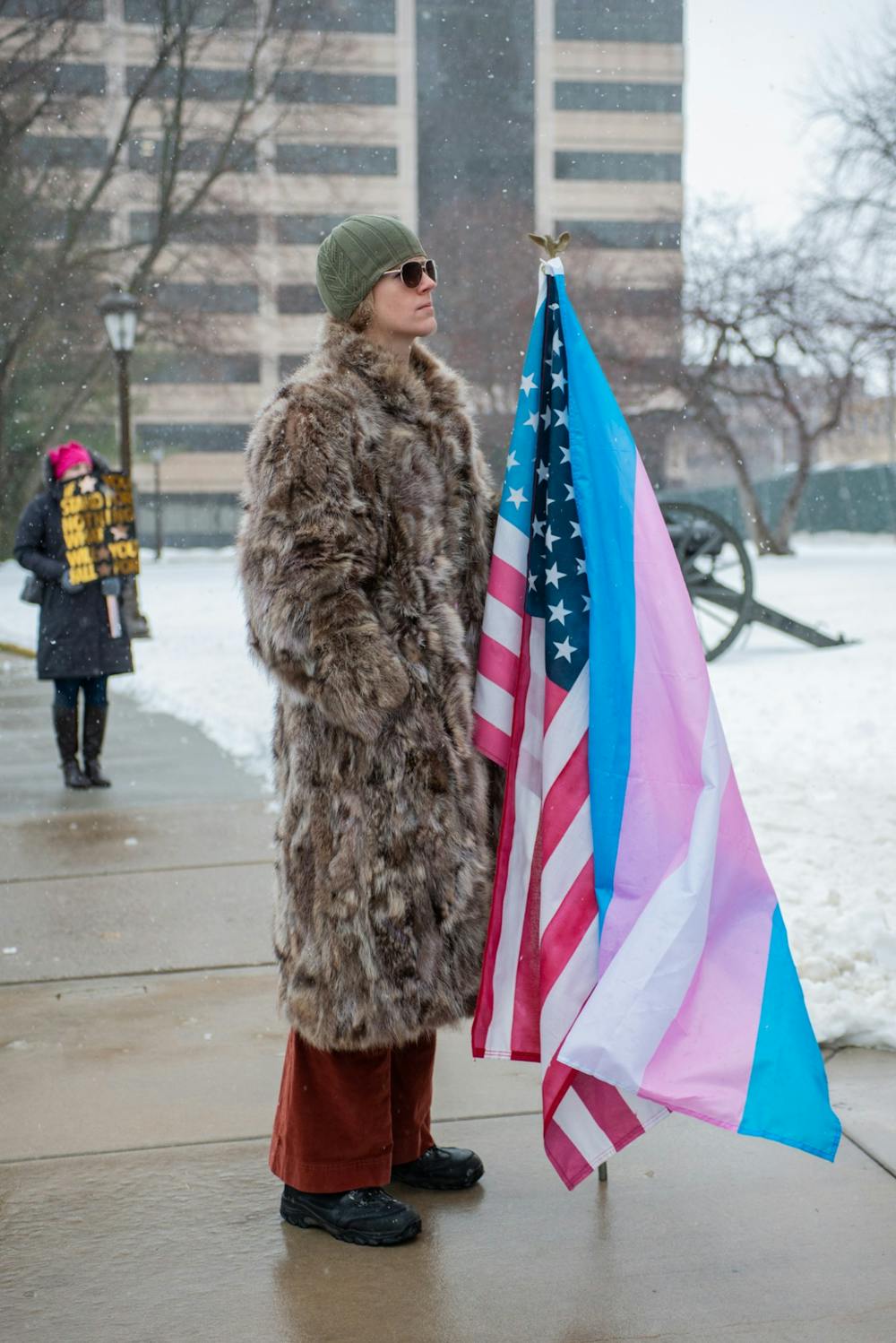 Micheala Hundersmarck supported women's rights her whole life when she was presenting as a man, but it wasn't until now that she has felt she "truly belongs here." Micheala stands in support of all women with her transgender and American flag during the Women’s March On Lansing 2020 Jan. 18, 2020, hosted by the Blue Brigade.