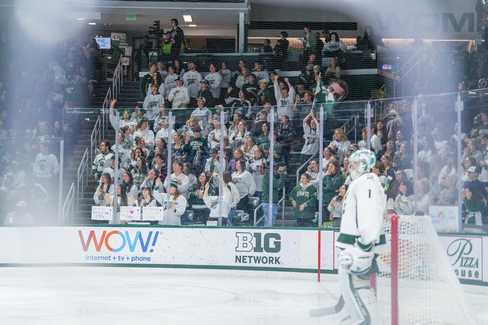 The MSU student section celebrates after the hockey team scores during a game against Canisius at Munn Ice Arena on Oct. 19, 2023. The Spartans beat the Griffins 6-3 in one of a two-game series.
