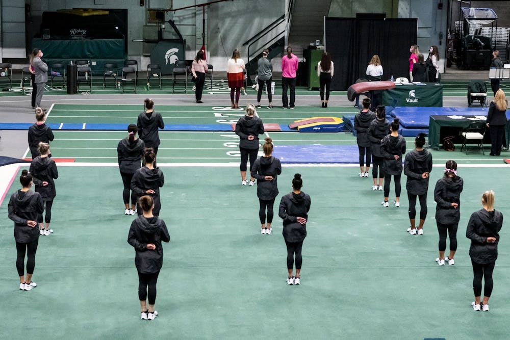 <p>MSU gymnastics stands for the Pledge of Allegiance at the season-opener Pink Meet for breast cancer awareness with Ohio State and Nebraska on Jan. 30, 2021 at the Jenison Field House. The Spartans won with a score of 195.775.</p>