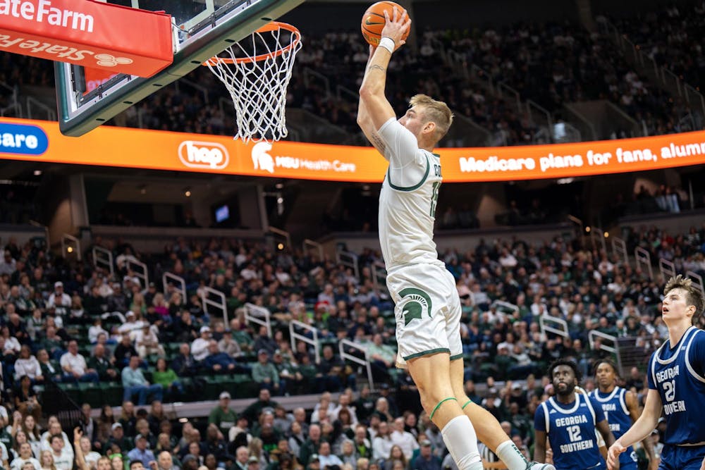 <p>MSU Sophomore Center Carson Cooper (15) flies to the rim during play against Georgia Southern at the Jack Breslin Student Events Center on Nov. 28, 2023.</p>