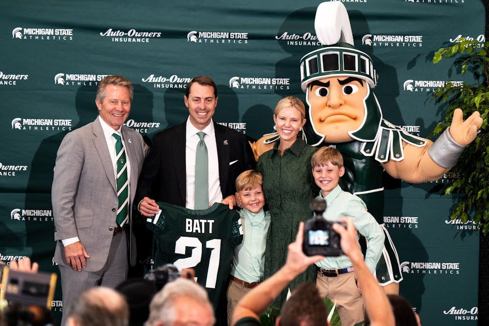 Michigan State University president Kevin Guskiewicz , new vice president and athletic director J. Batt and his family pose for a photo in East Lansing, Michigan on June 4, 2025.