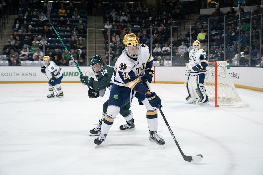 <p>Notre Dame defenseman Drew Bavaro protects the puck from MSU freshman forward Tiernan Shoudy at Compton Family Ice Arena in Notre Dame, IN on Friday, March 3, 2023. Shoudy recorded two shots during a game where the Spartans went scoreless.</p>
