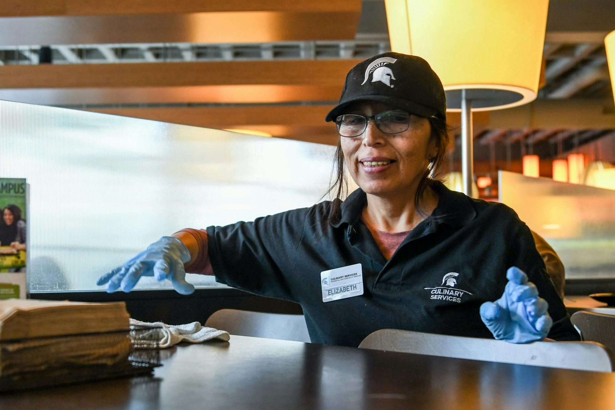 <p>Elizabeth, a dining hall employee, cleans the tables at Shaw on Jan. 23, 2020.</p>