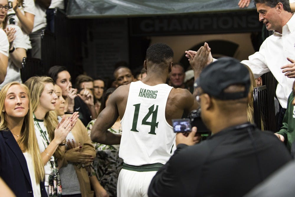 Senior guard Eron Harris (14) high fives a fan after men's basketball game against the University of Wisconsin on Feb. 26, 2017 at Breslin Center. The Spartans defeated the Badgers, 84-74.
