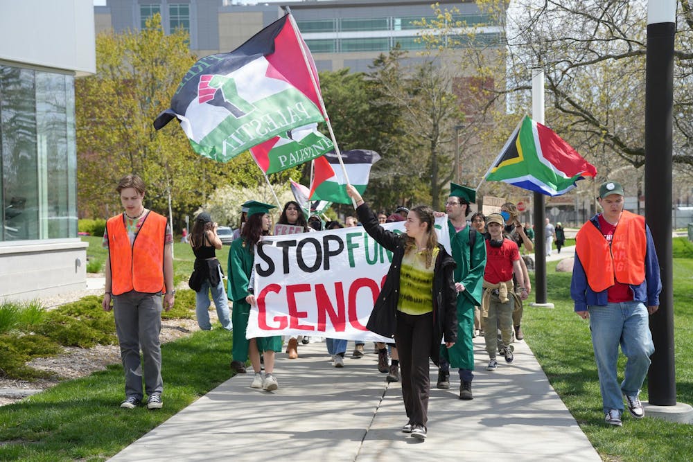 MSU student protestors march from the Gaza solidarity encampment to the Breslin Center on April 26, 2024. They chanted for the university to divest from Israel, chanting "Not another nickel, not another dime, no more money for Israel's crimes."