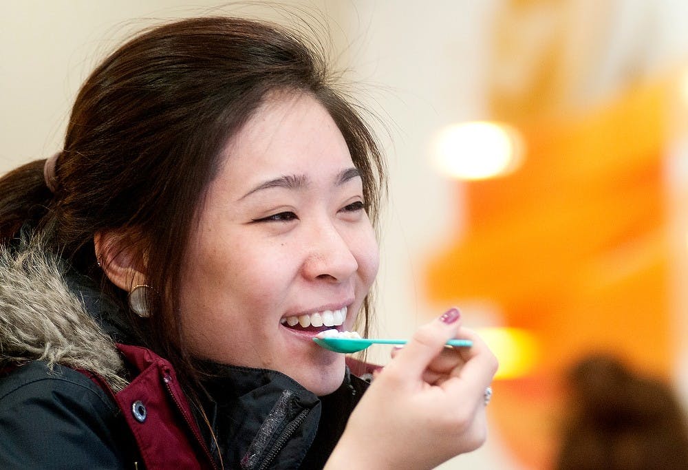	<p>Kinesiology junior Sun Hye Yim eats frozen yogurt Thursday at Tutti Frutti, 515 E. Grand River Ave. The frozen yogurt shop will have their grand opening today. They&#8217;ve been open for the past two weeks for a &#8220;soft opening.&#8221; Julia Nagy/The State News</p>