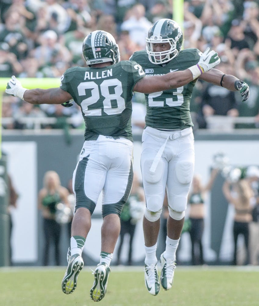 	<p>Junior linebacker Denicos Allen, 28, and junior safety Jairus Jones celebrate a recovered fumble during a game against Ohio State on Saturday, Sept. 29, 2012 at Spartan Stadium. The Spartans recovered an Ohio State fumble. Julia Nagy/The State News</p>