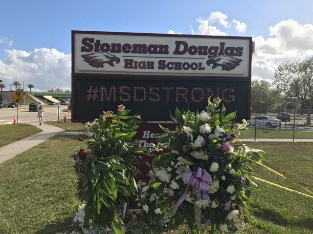 <p>The Marjory Stoneman Douglas High School sign has a display of wreaths after the Feb. 14 shooting. <strong>Courtesy Photo of Ron Lieberman.</strong></p>