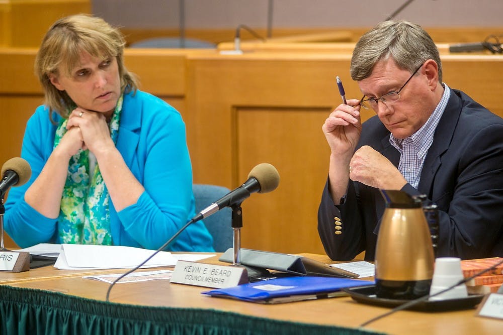 	<p>From left, East Lansing Mayor Diane Goddeeris and Councilmember Kevin Beard listen to Councilmember Vic Loomis, (not pictured) , Aug. 6, 2013, at City Hall, 410 Abbot Road. The council selected <span class="caps">DTN</span> Management Co. to develop the Park District project in an unanimous vote. Justin Wan/The State News</p>