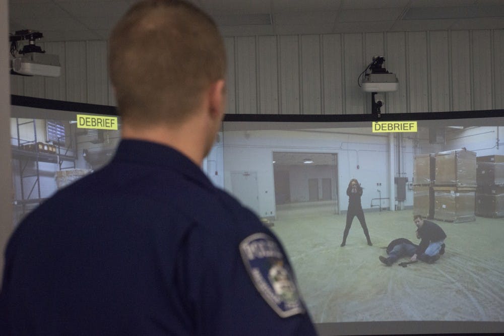 Officer Dan Childs demonstrates the Milo Range Theatre, a 300 degree use of force simulators that uses real life scenarios to help train officers on Feb. 18, 2016 at the MSUPD shooting range on 5400 Jolly Road.  There are over 600 different scenarios for each single screen.