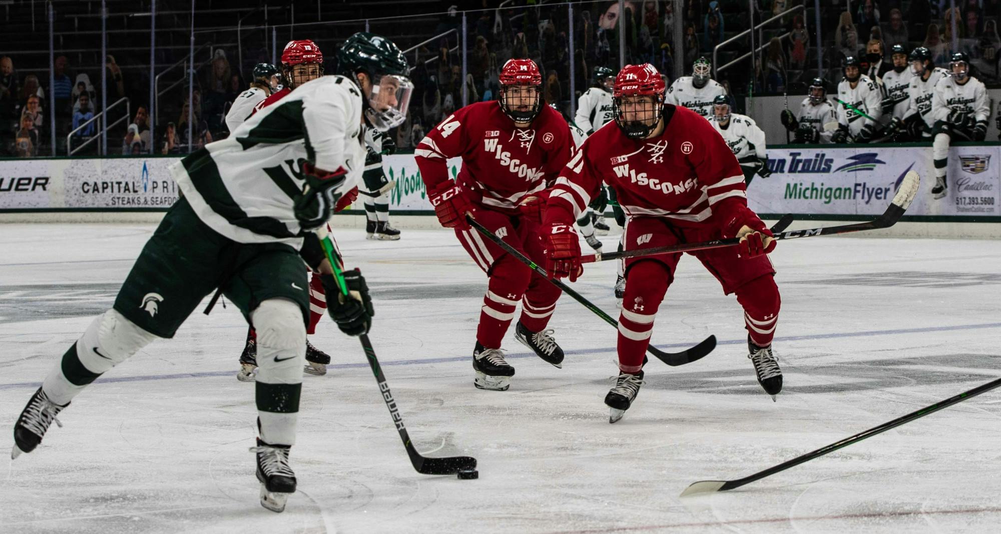 <p>Freshman forward Kyle Haskins (17) navigates through the Wisconsin defense in the first period. The Badgers shutout the Spartans 4-0 at Munn Ice Arena on Mar. 5, 2021. </p>