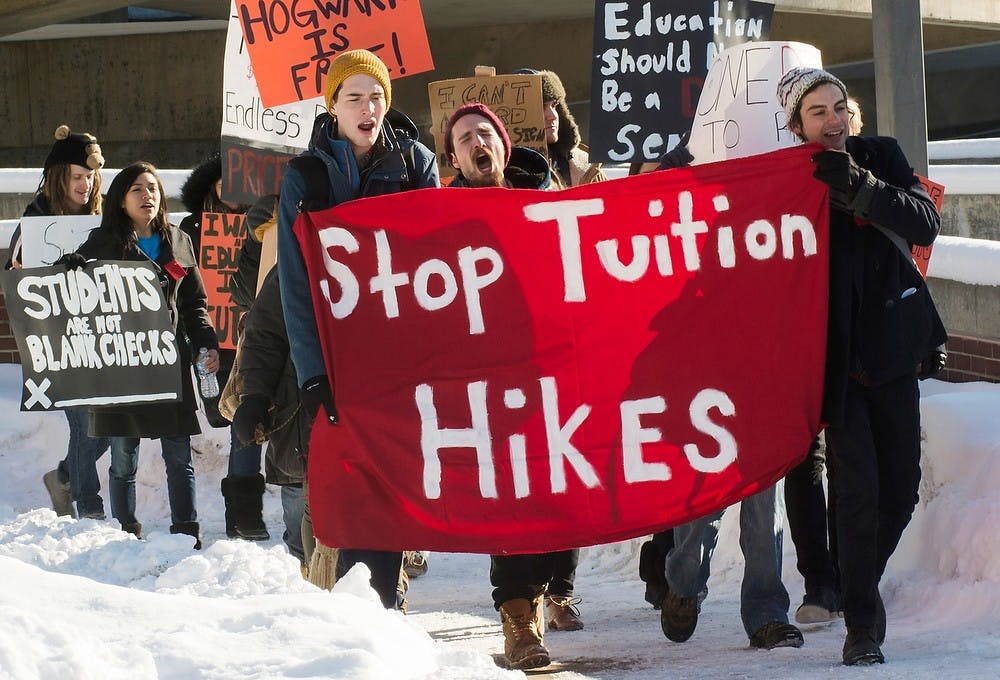 	<p>From left, James Madison sophomore Andrew Gibson, philosophy senior Spencer Perrenoud, and history and jazz sophomore Duncan Tarr lead a protest before the State of the University address on Feb. 11, 2014, near the Wharton Center parking ramp. The protest was organized by <span class="caps">MSU</span> Students United. Casey Hull/The State News</p>