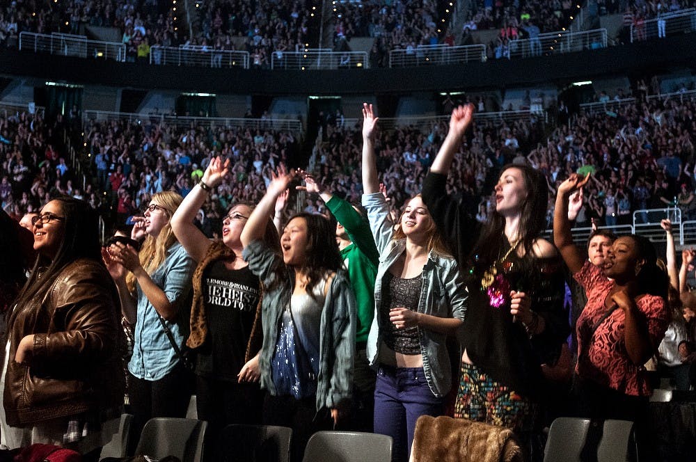 	<p>Crowd members jump around to a song performed by Macklemore and Ryan Lewis at the concert on Tuesday, March 19, 2013, at Breslin Center. The concert, hosted by <span class="caps">ASMSU</span>, was Macklemore&#8217;s third time performing in the Lansing area.</p>