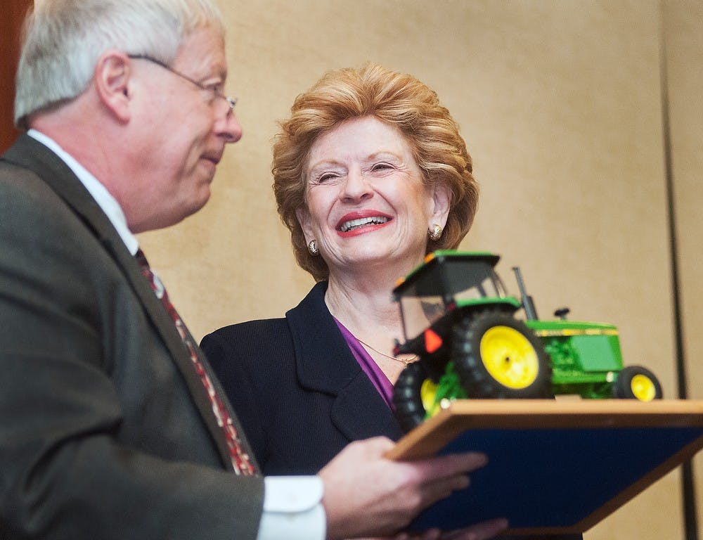	<p>Jim Byrum, president of the Michigan Agri-Business Association presents a plaque to Sen. Debbie Stabenow, D-Mich., after speaking to an audience Tuesday, Jan. 15, 2013, at the Radisson Hotel, 111 N.Grand Ave., in Lansing. Stabenow spoke about the future of the agriculture business as a part of the <span class="caps">MABA</span>&#8217;s 2013 Winter Conference. Adam Toolin/The State News</p>