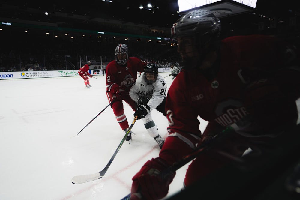 MSU senior forward Daniel Russel (20) fights for the puck at the Munn Area in East Lansing, MI, on Feb. 27, 2026.
