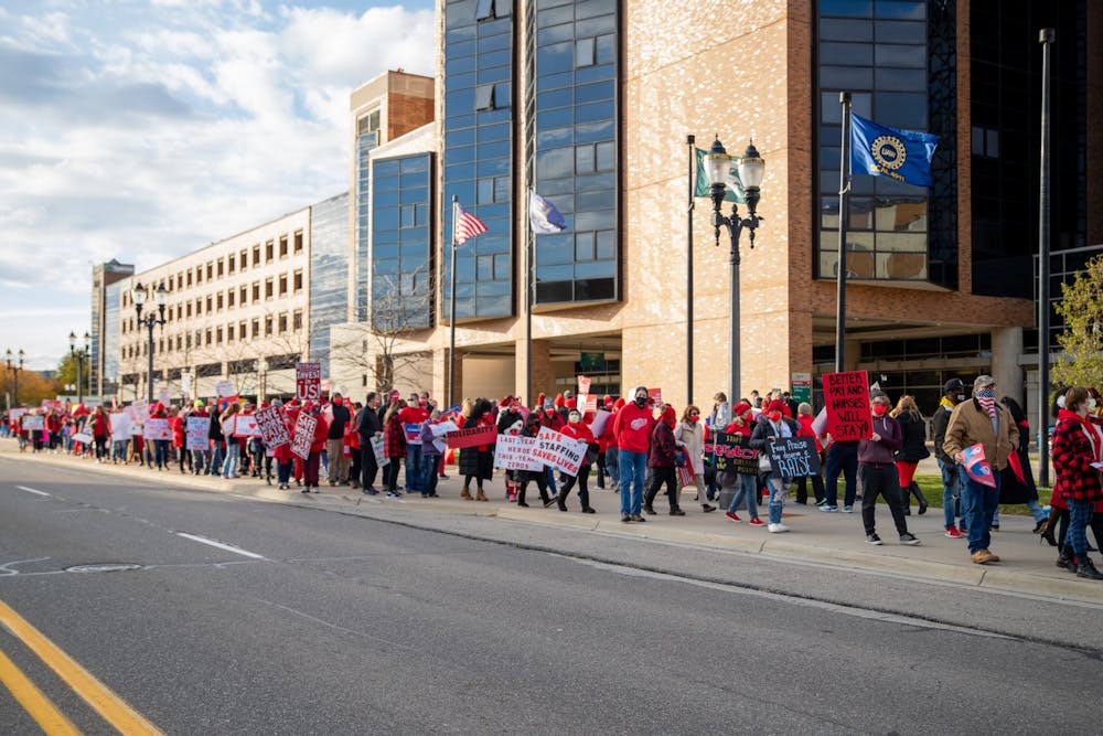 <p>Sparrow nurses along with supporters of them picket along Michigan Avenue in Lansing on Nov. 3, 2021. </p>