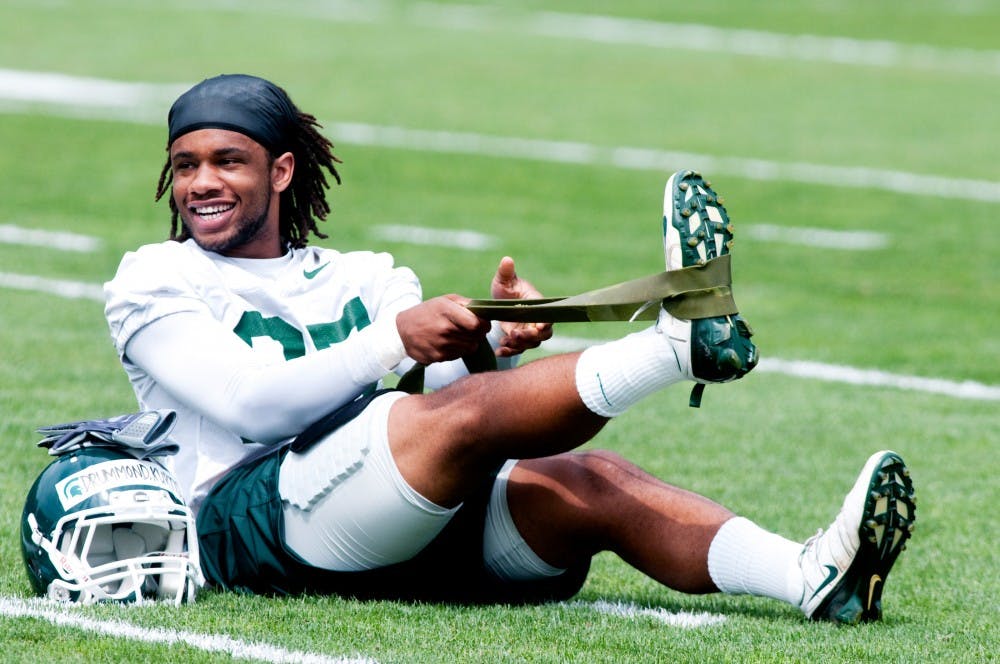 	<p>Freshman safety Kurtis Drummond stretches out his leg before practice Monday afternoon at the football practice field near the Duffy Daugherty Football Building. </p>