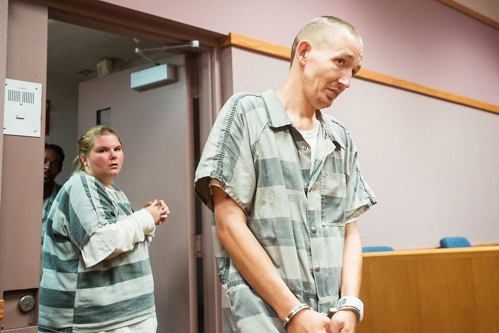 <p>Anthony Shearer, right, and Cynthia Spade, left, enter the courtroom for a pre-trial conference July 8, 2014, in East Lansing's 54-B District Court. Both suspects stand trial for falsely reporting a bomb threat to Spartan Stadium. Corey Damocles/The State News </p>