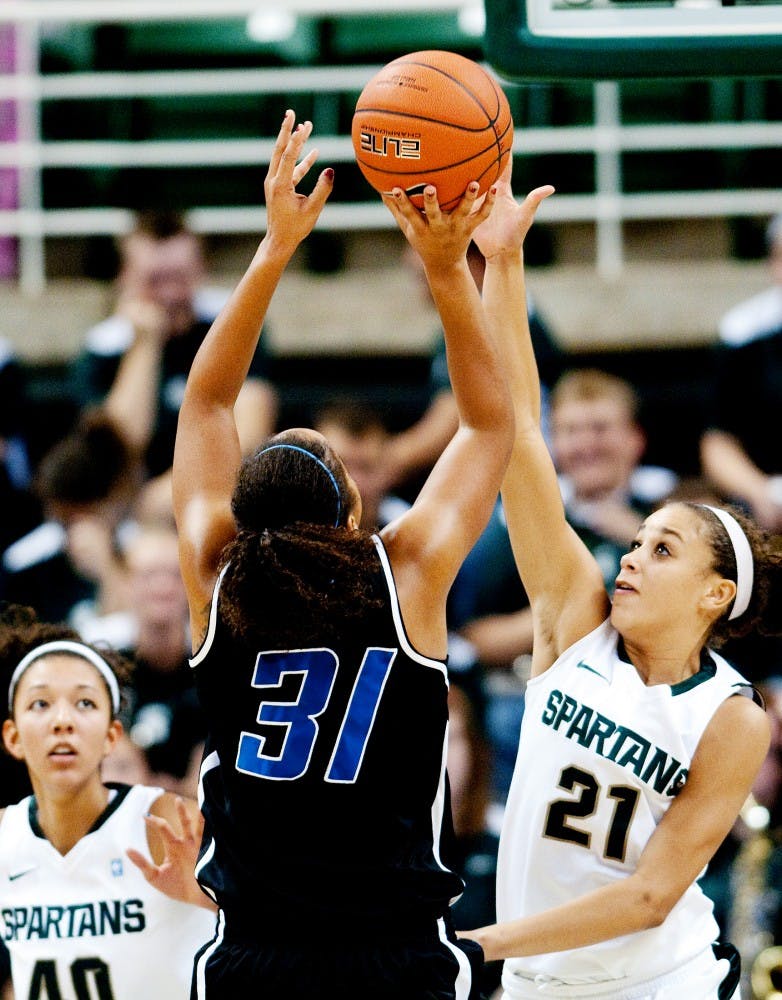 Sophomore guard Klarissa Bell contests Grand Valley guard Briauna Taylor as she goes up for a shot during the second half. The Spartans defeated the Lakers, 75-23, in an exhibition game on Sunday afternoon at Breslin Center. Josh Radtke/The State News
