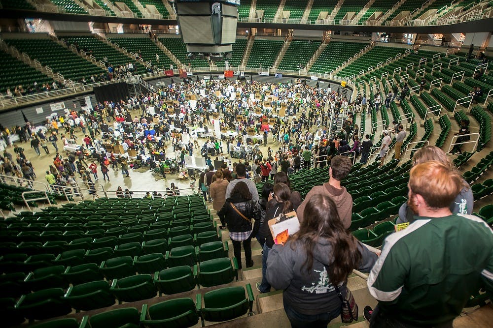 <p>Students make their way down to the floor Sept. 14, 2014, during Sparticipation at Breslin Center. State News File Photo. </p>