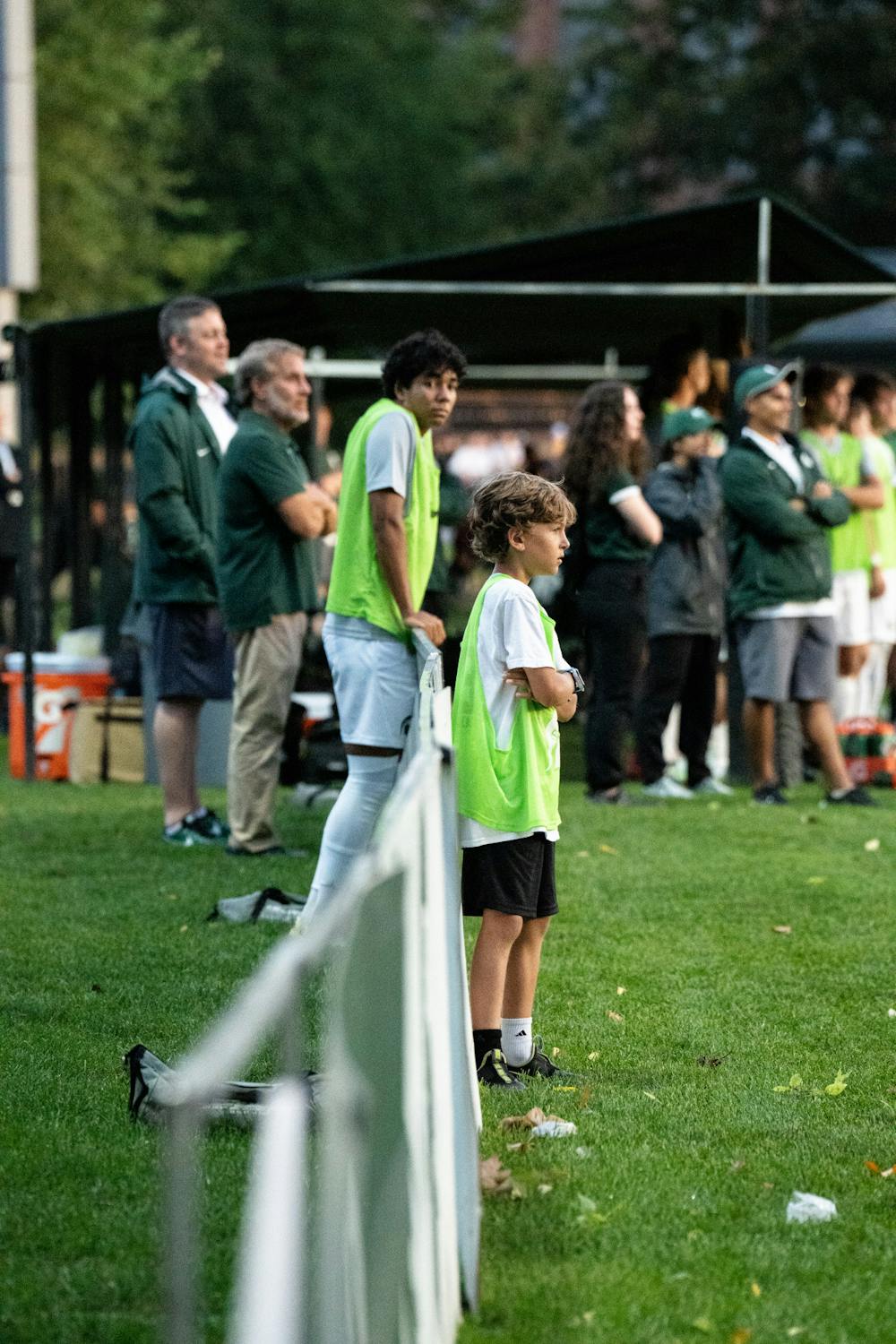 <p>Freshman forward Tyler Crawford looks on at the young ball boy watching the Spartans play against Notre Dame on Aug. 29, 2022.</p>