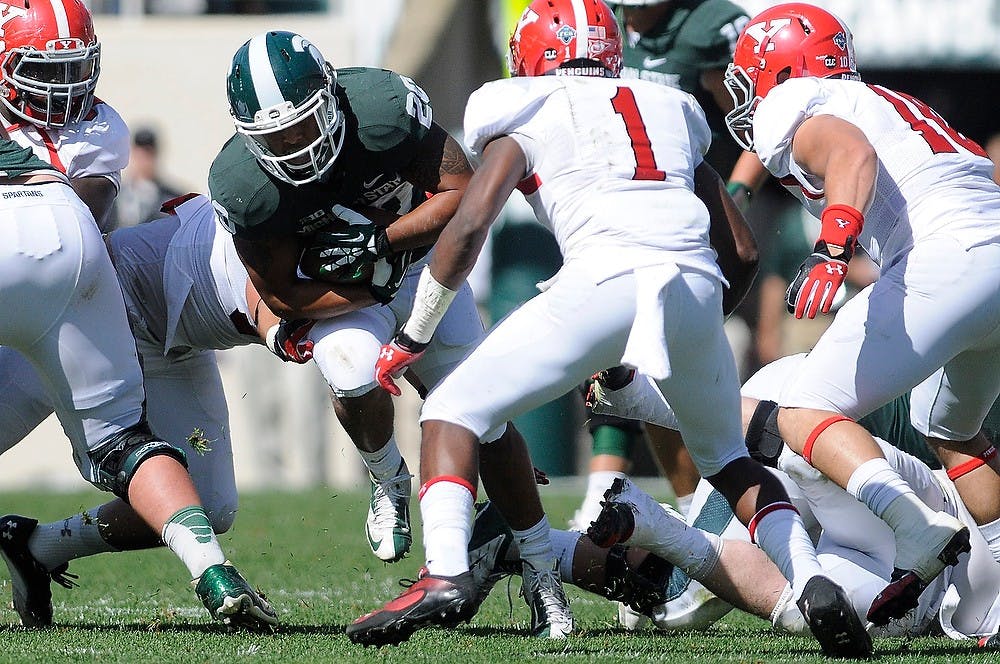 	<p>Junior running back Nick Hill runs the ball as Youngstown State players try to make the tackle Sept. 14, 2013 at Spartan Stadium. The Spartans had a strong showing against Youngstown State in a 55-17 victory. Khoa Nguyen/ The State News</p>