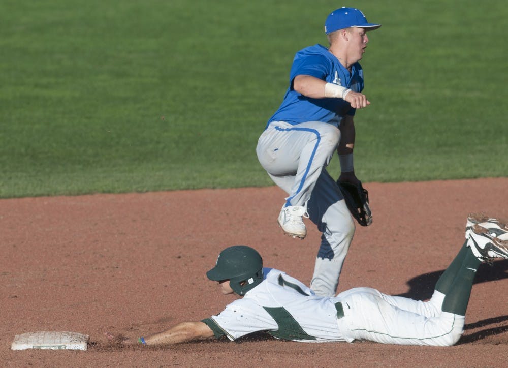 <p>Junior pitcher Ethan Landon slides into second base underneath Air Force infielder Ryan Robb in the ninth inning during the baseball exhibition game against Air Force on Sept. 19, 2015 at McLane Stadium. MSU baseball season begins in February. Jack Stephan/The State News</p>