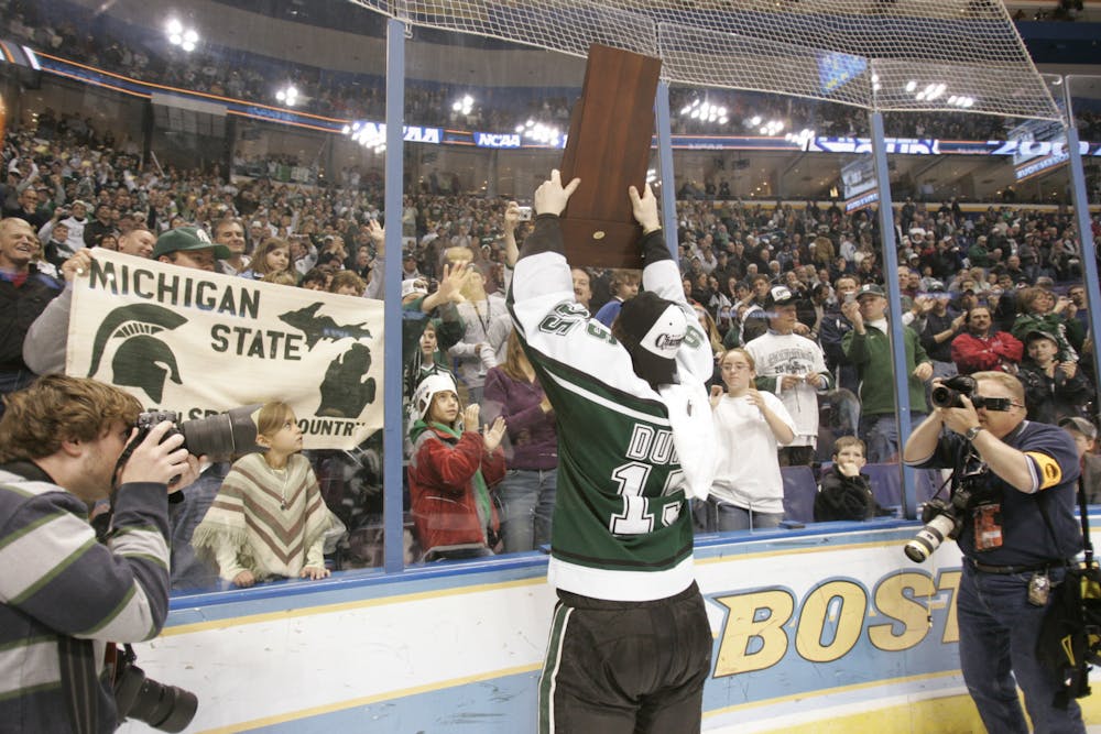 <p>MSU defenseman Jeff Dunne hoists the NCAA Championshp Trophy following Michigan State&#x27;s 3-1 victory over Boston College. Photo courtesy of MSU Athletics. </p>